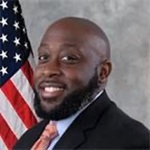 Official portrait of Chief Ruffin with an American flag in the background.