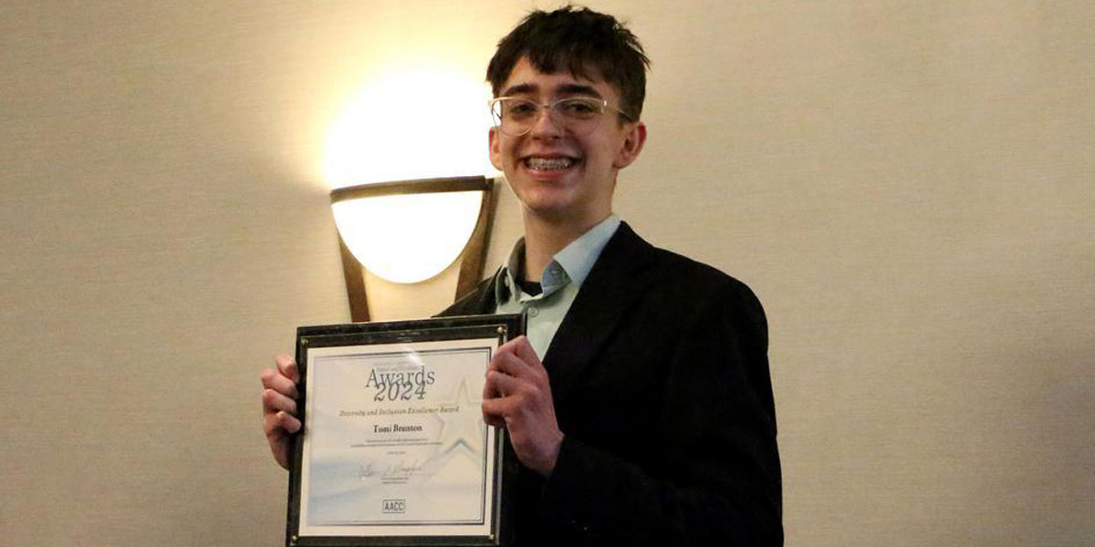 AACC student, Tomi Brunton, holding a certificate award.