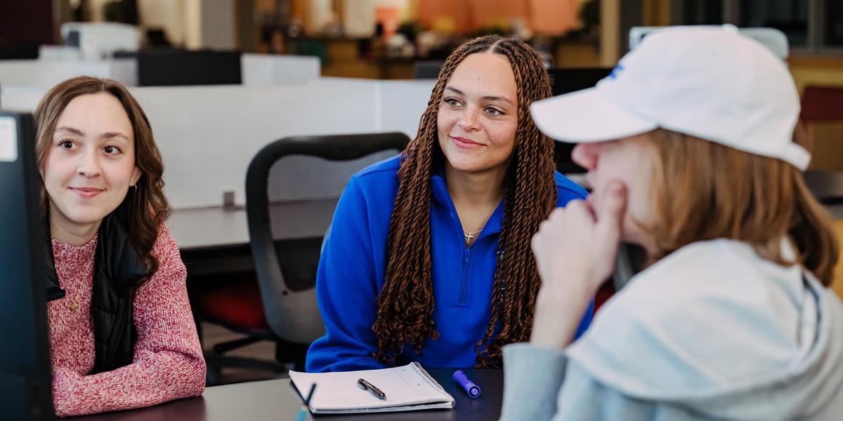AACC students looking at computer.
