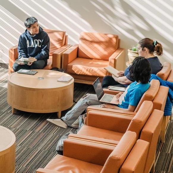Students sitting in library area.